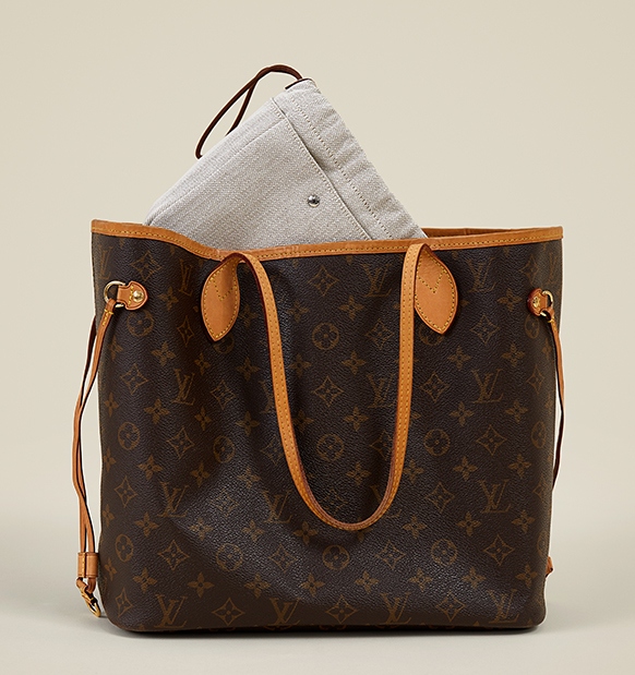 Louis Vuitton Neverfull With Leather Vachetta Trim And A Pouch Peeking Out Of The Bag