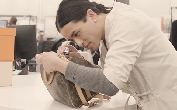 Kevin Ngo Inspects A Louis Vuitton Speedy Bag