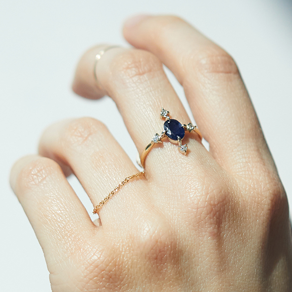 The RealReal x Catbird. Model wearing Sapphire Moonflower ring in gold with sapphire and diamonds, sustainable jewelry from upcycled collection