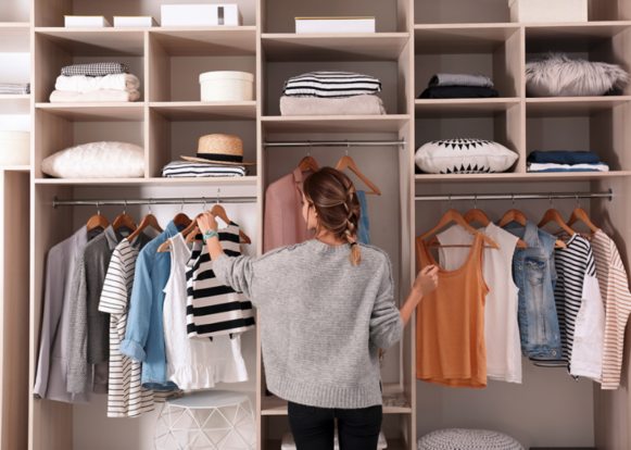 Woman with clothes in closet